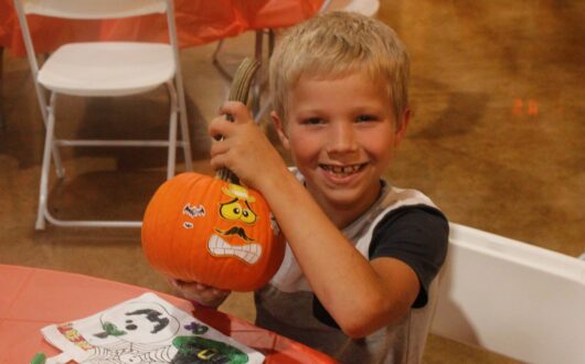 boo-springs-boy-holding-sticker-pumpkin